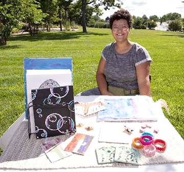 Girl sitting at craft table at Youth Craft Fair.