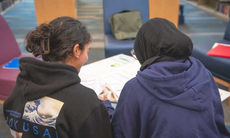 Teens working and reading together.