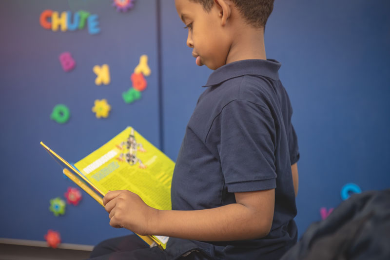 Kid reading book.