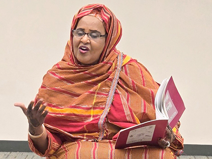 Fardousa reading a book during a Somali storytime.