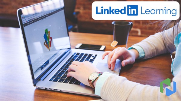 Woman typing on laptop with Linked in Learning logo