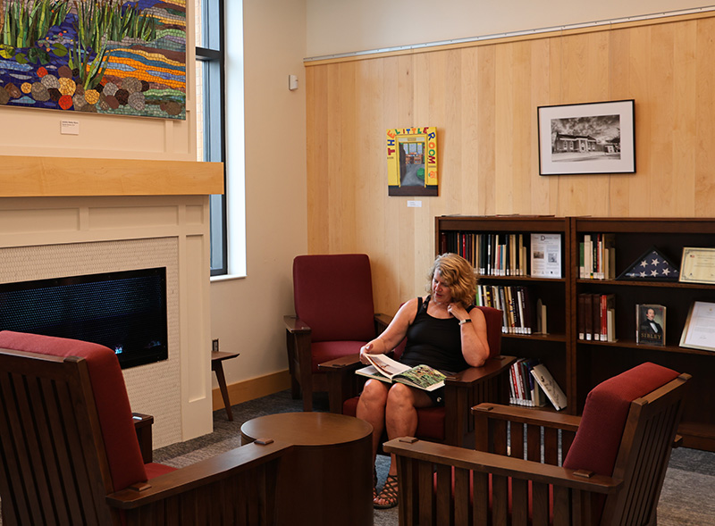 Woman sitting in library reading.