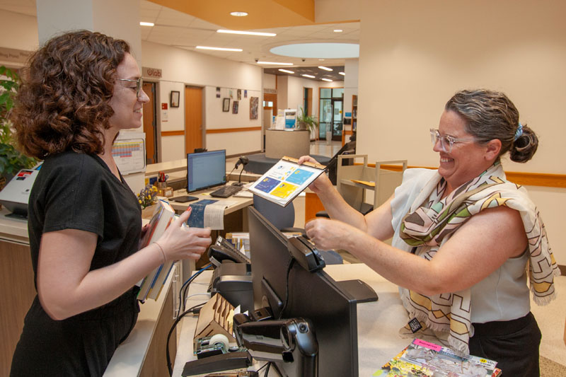 Person getting a library card at the service desk.