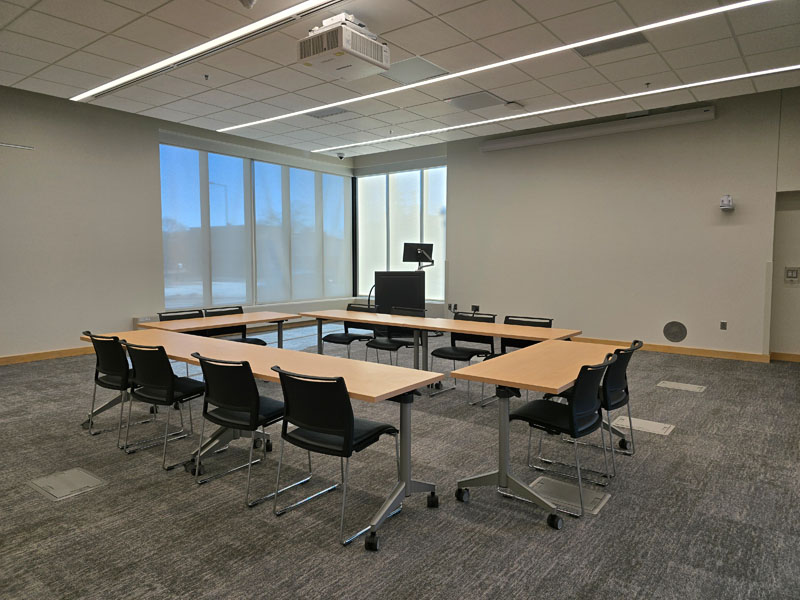 Kaposia Large Meeting Room with four tables arranged in a rectangle and 12 chairs. 
