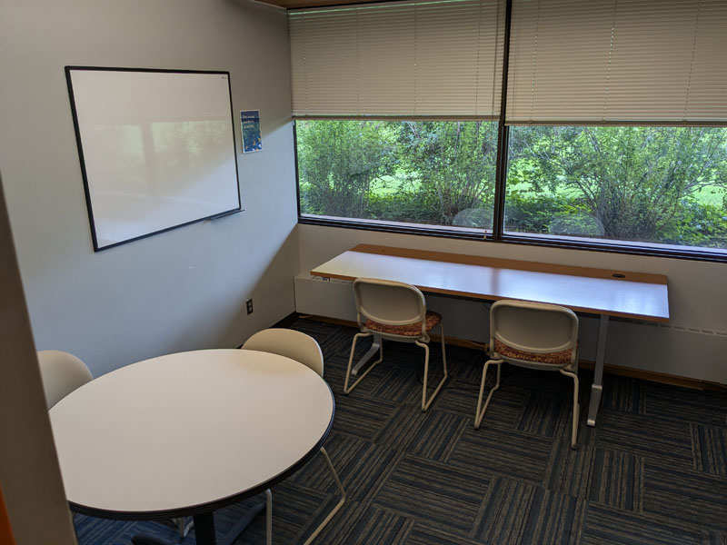 Wescott Meeting Room 215 with two tables and four chairs.