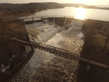 Photo of a bridge and dam taken from above with a drone.