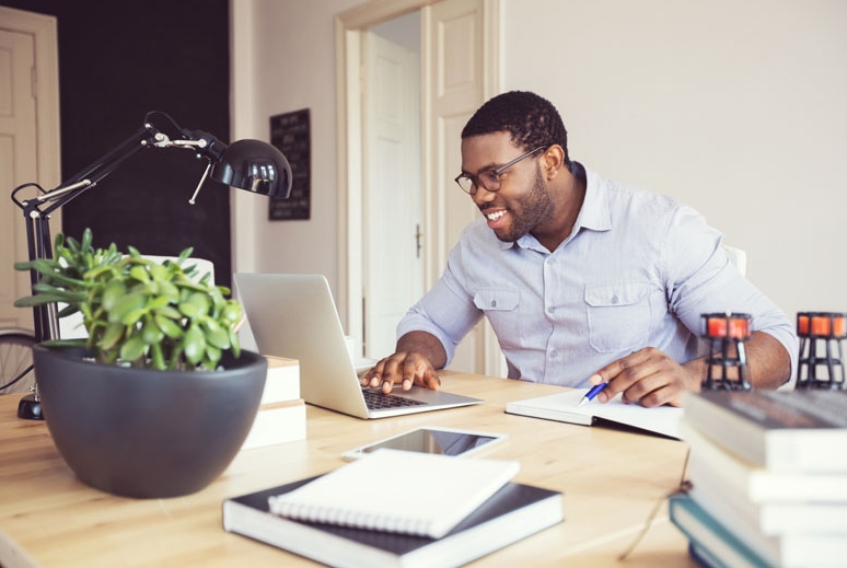 Man at at desk with a laptop