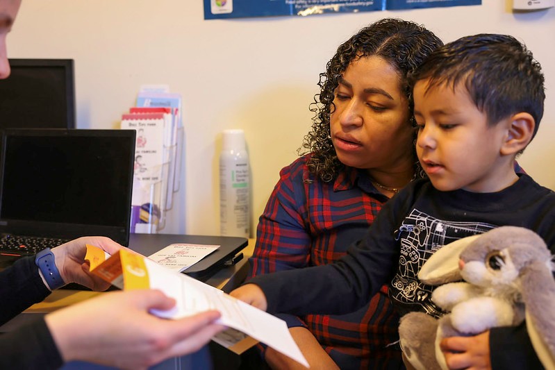 Mom and child looking at flyer in WIC office.