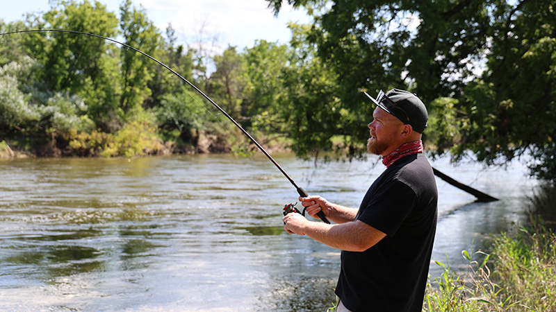 A man fishing on a river