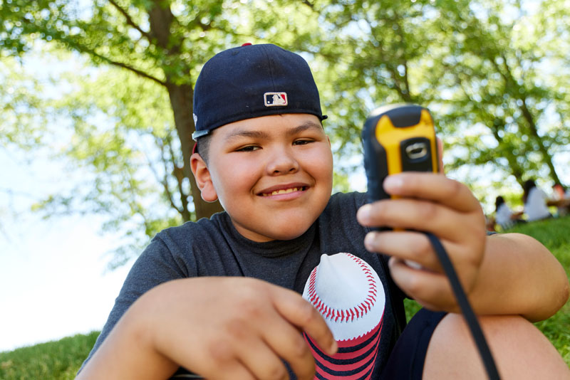 A boy looking at a GPS device.