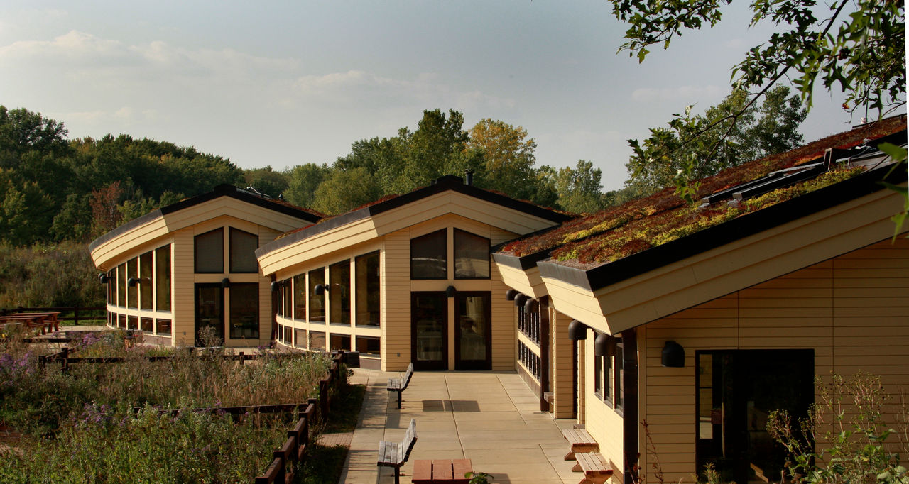 Three buildings with green roofs.