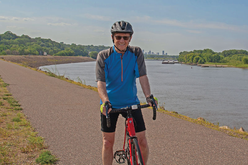 Man on a bike next to a body of water