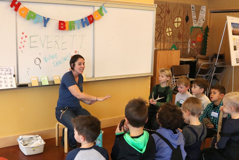 A park naturalist leading an activity at a children's birthday party.