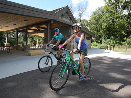 Two people on bicycles at a Big Rivers Regional Trail trailhead.
